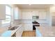 Modern kitchen with white cabinets, granite countertops, and stainless steel appliances at 1805 Augustine St, Monroe, NC 28112