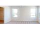 Well-lit bedroom with neutral carpeting and dual windows at 1809 Augustine St, Monroe, NC 28112