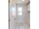 Bright laundry room with tile flooring and white cabinets at 1809 Augustine St, Monroe, NC 28112