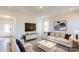 Bright living room featuring comfortable seating and a large TV at 1809 Augustine St, Monroe, NC 28112