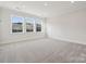 Bright bonus room with neutral carpet and large windows at 116 Brooke Forest Ct, Mooresville, NC 28115