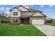 Two-story house with brick and siding exterior, a large yard, and a two-car garage at 116 Brooke Forest Ct, Mooresville, NC 28115