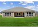 Spacious backyard showcasing a covered porch perfect for outdoor lounging and entertaining with plenty of natural light at 120 Brooke Forest Ct, Mooresville, NC 28115