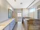 Luxurious bathroom with dual vanities, tiled floors, and a glass-enclosed shower, offering a spa-like experience at 120 Brooke Forest Ct, Mooresville, NC 28115