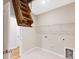 Utility closet with open wooden staircase for storage and tile flooring at 120 Brooke Forest Ct, Mooresville, NC 28115
