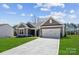 Charming single-story home with a manicured lawn and a two-car garage, showcasing modern curb appeal at 120 Brooke Forest Ct, Mooresville, NC 28115