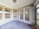 Cozy screened-in porch with double glass doors, a ceiling fan, and ample natural light, perfect for relaxing at 120 Brooke Forest Ct, Mooresville, NC 28115