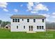 Bright white two-story home featuring sliding glass patio doors and a spacious backyard at 126 Brooke Forest Ct, Mooresville, NC 28115
