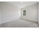 Simple bedroom with carpeted floor and a window at 126 Brooke Forest Ct, Mooresville, NC 28115
