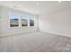 Bright bonus room with three windows and grey carpet at 126 Brooke Forest Ct, Mooresville, NC 28115