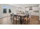 Kitchen and dining area with hardwood floors and modern white cabinets at 126 Brooke Forest Ct, Mooresville, NC 28115