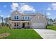Charming two-story home with a manicured lawn, covered entry, and attached two-car garage at 126 Brooke Forest Ct, Mooresville, NC 28115