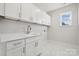 Laundry room with white cabinets and quartz countertops at 126 Brooke Forest Ct, Mooresville, NC 28115
