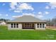 Exterior view showcasing a spacious backyard and covered patio at 132 Brooke Forest Ct, Mooresville, NC 28115
