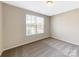 Bright bedroom boasts a large window allowing natural light and cozy carpet flooring at 132 Brooke Forest Ct, Mooresville, NC 28115
