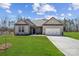 Charming single-story home with a well-manicured lawn and attached two-car garage at 132 Brooke Forest Ct, Mooresville, NC 28115