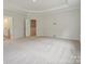 Large bedroom with plush carpeting and an ensuite bathroom at 223 E Warfield Dr, Mooresville, NC 28115