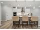 Modern kitchen with white cabinets, stainless steel appliances, and an island at 223 E Warfield Dr, Mooresville, NC 28115