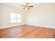 Bright bedroom with hardwood floors and a large window at 7805 Medlin Rd, Monroe, NC 28112