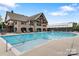 Community pool with adjacent clubhouse and covered seating area at 82220 Standing Oak Dr, Charlotte, NC 28278