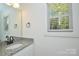 Simple bathroom with granite vanity and window at 69 Hill St, Salisbury, NC 28144