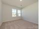 Charming bedroom with a view and carpet flooring at 10505 Boudreaux St, Huntersville, NC 28078