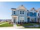 Two-story townhome with light blue siding, and a grassy front yard at 10505 Boudreaux St, Huntersville, NC 28078