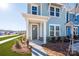 Townhome's front entrance with a gray door and stone accents at 10505 Boudreaux St, Huntersville, NC 28078