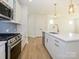 Modern kitchen with white cabinets, white quartz countertops and island at 10505 Boudreaux St, Huntersville, NC 28078