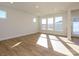 Spacious living room with hardwood floors and large windows at 10505 Boudreaux St, Huntersville, NC 28078