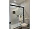 Bathroom with marble tile, walk-in shower, and modern fixtures at 11052 Cedar View Rd, Charlotte, NC 28226