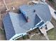 Aerial view of a charming light-blue house with a new gray roof and wooden deck at 200 Cleveland Ave, Shelby, NC 28150