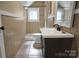 Bathroom with gray vanity, shower, and tile flooring at 200 Cleveland Ave, Shelby, NC 28150