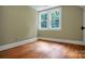 Bright bedroom with hardwood floors and two windows at 200 Cleveland Ave, Shelby, NC 28150