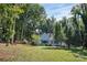 Light blue house on a grassy lot with mature trees surrounding at 200 Cleveland Ave, Shelby, NC 28150