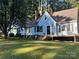 Charming light blue house with a spacious deck, surrounded by lush greenery at 200 Cleveland Ave, Shelby, NC 28150