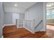 Upper hallway with hardwood floors and white railing at 200 Cleveland Ave, Shelby, NC 28150