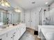 Spacious bathroom with double sink vanity, shower and soaking tub combination, and tile floor at 2715 Ballade Dr, Matthews, NC 28105