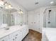 Bright bathroom featuring double vanity, large mirror, walk-in shower and tile floor at 2715 Ballade Dr, Matthews, NC 28105