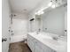 A well-lit bathroom featuring a double sink vanity and a shower-tub at 2715 Ballade Dr, Matthews, NC 28105