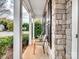 Covered front porch showing stone detail, white columns, and ample seating area at 2715 Ballade Dr, Matthews, NC 28105