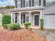 Inviting front porch with stone accents, space for seating, and meticulous landscaping at 2715 Ballade Dr, Matthews, NC 28105