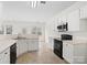 Clean kitchen with white cabinets and modern black appliances at 2715 Ballade Dr, Matthews, NC 28105