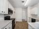 A well-lit kitchen featuring white cabinets, dark appliances and tile floors at 2715 Ballade Dr, Matthews, NC 28105