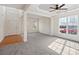 Bright living room with large windows and a ceiling fan at 2715 Ballade Dr, Matthews, NC 28105