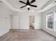 A large, bright main bedroom featuring a ceiling fan, walk-in closet and ensuite bathroom at 2715 Ballade Dr, Matthews, NC 28105