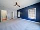 Large bedroom with ceiling fan, two windows, and a blue accent wall at 615 Real Quiet Ct, York, SC 29745