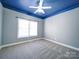 Bright bedroom featuring a window and blue ceiling at 615 Real Quiet Ct, York, SC 29745