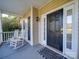 Front porch with rocking chairs and a black front door at 615 Real Quiet Ct, York, SC 29745