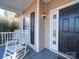 Inviting front porch with rocking chairs and dark door at 615 Real Quiet Ct, York, SC 29745